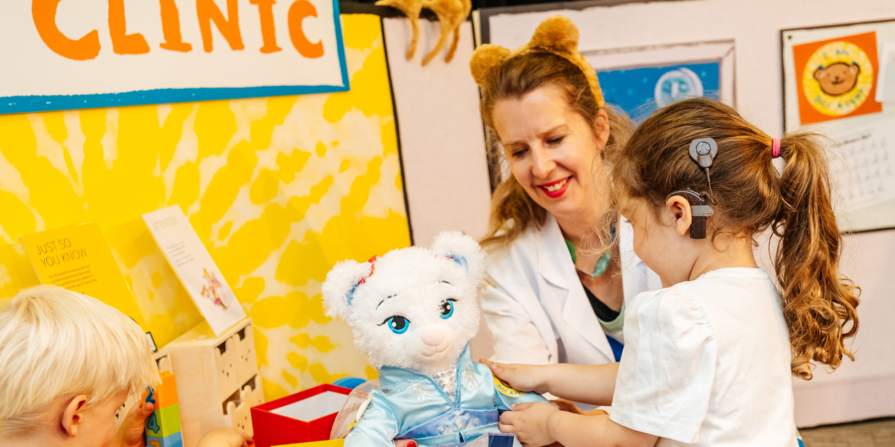 Doctor with a child and teddy bear at the Bear Ear Clinic