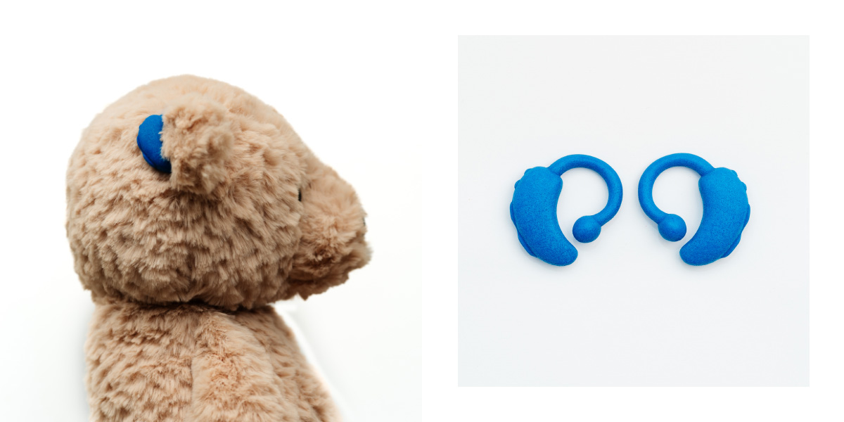 Images shows plush bear and a pair of blue toy hearing aids