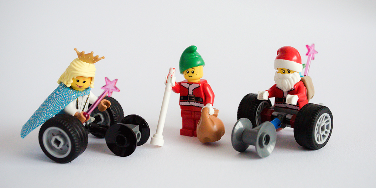 #ToyLikeMe makeover image showing Lego wheelchair mini-figure Santa and fairy with wheelchairs and an elf with a white cane.