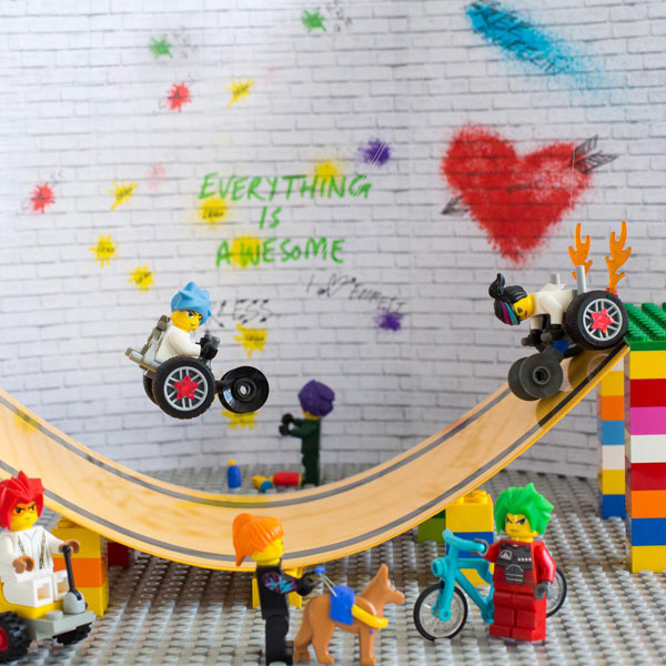 #ToyLikeMe makeover image showing Lego wheelchair skate park featuring mini-figures with wheelchairs.