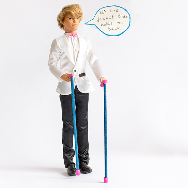 #ToyLikeMe makeover image showing a Ken doll with two walking sticks. There is a speech bubble which reads, 'It's the jacket that holds me back...'