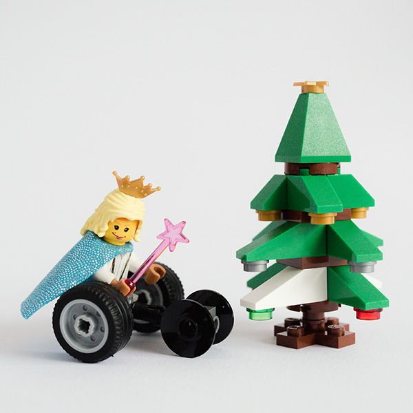 #ToyLikeMe makeover image showing Lego wheelchair mini-figure and Christmas tree.