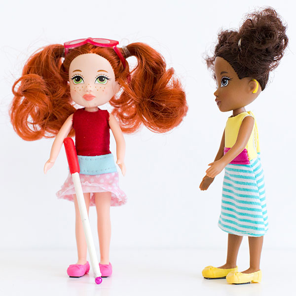 #ToyLikeMe makeover image showing two Moxie dolls, one with a white cane and the other with a hearing aid.