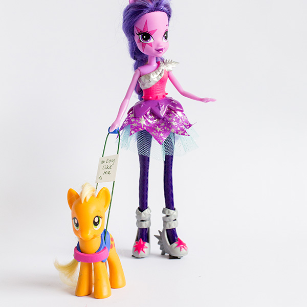 #ToyLikeMe makeover image showing My Little Pony doll with a guide pony. The pony's harness reads '#toylikeme'.