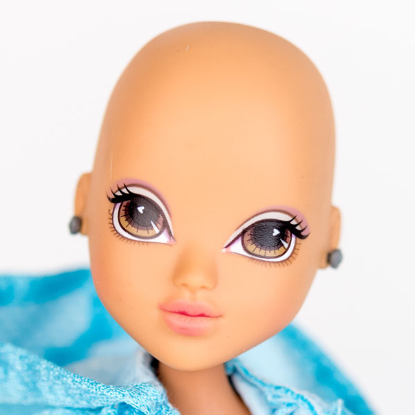 Close up of Moxie doll with no hair, smooth head and earrings.