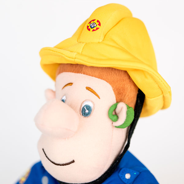 Plush Fireman Sam doll rocking a green 3D printed hearing aid.