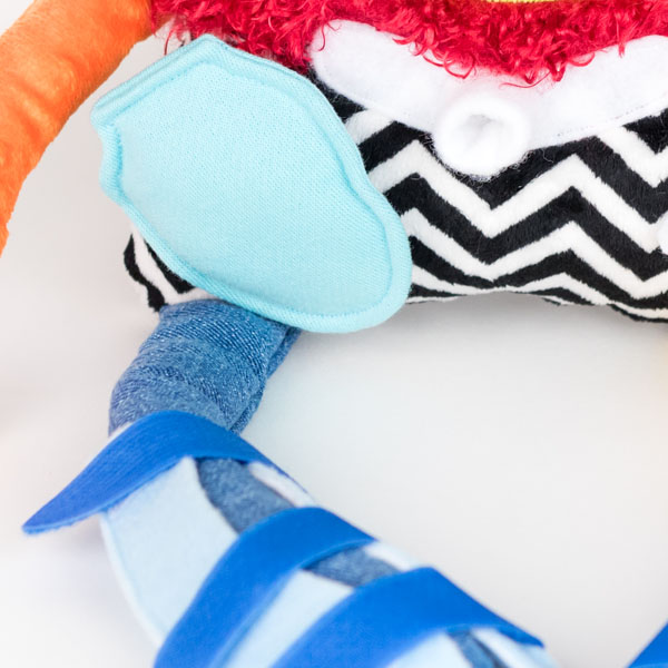 Close up image of Weesie Pals trach tube, ostomy pouch and leg splint.