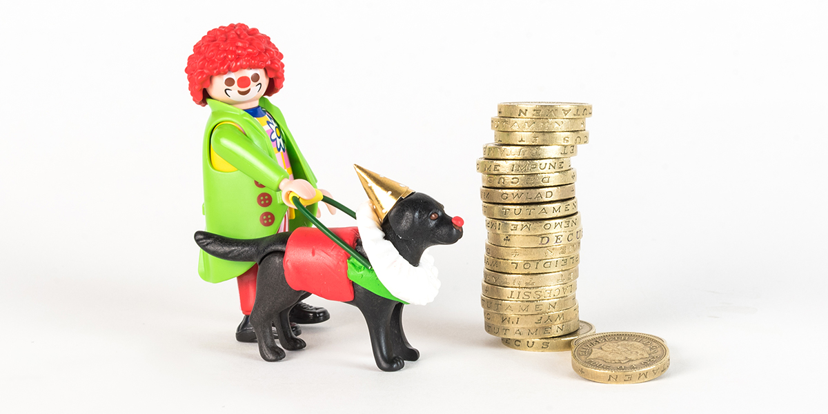 #ToyLikeMe makeover image of Playmobil clown figure with black guide dog. The dog is wearing a model clown