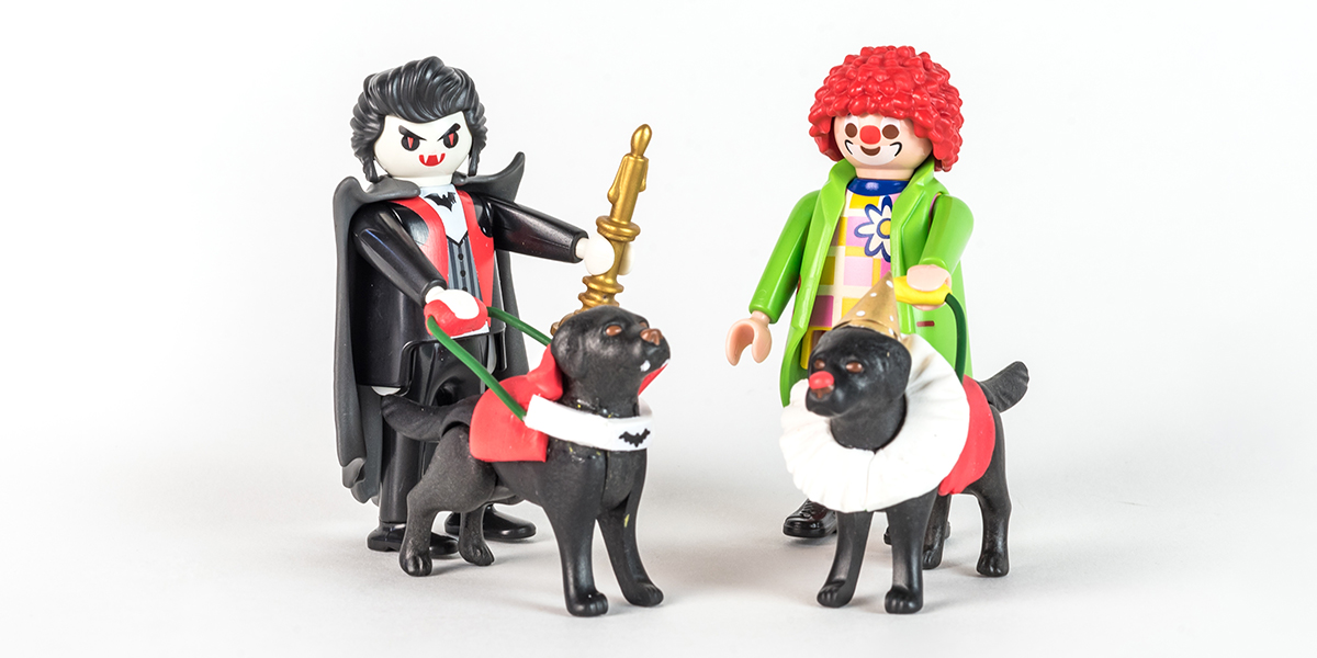 #ToyLikeMe makeover image showing Playmobil figures of dracula and a clown with guide dogs.
