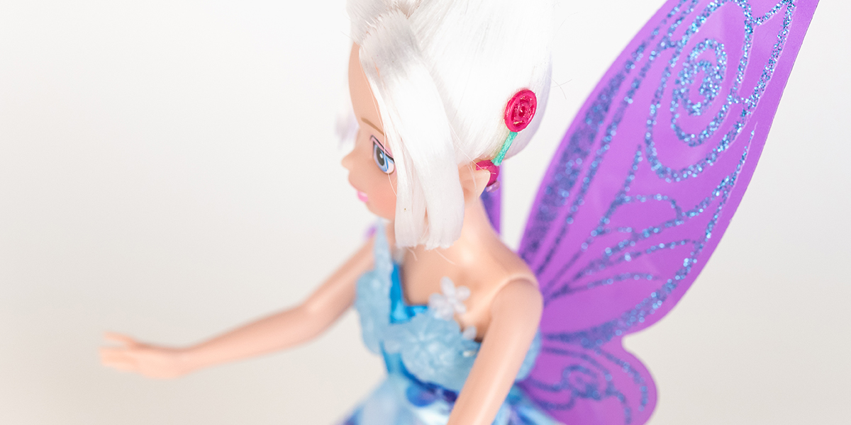 #ToyLikeMe makeover image showing Disney Periwinkle doll with hot pink model cochlear implant.