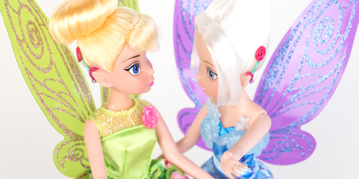 #ToyLikeMe makeover image showing Disney Tinkerbell and Periwinkle dolls with hot pink model cochlear implants.