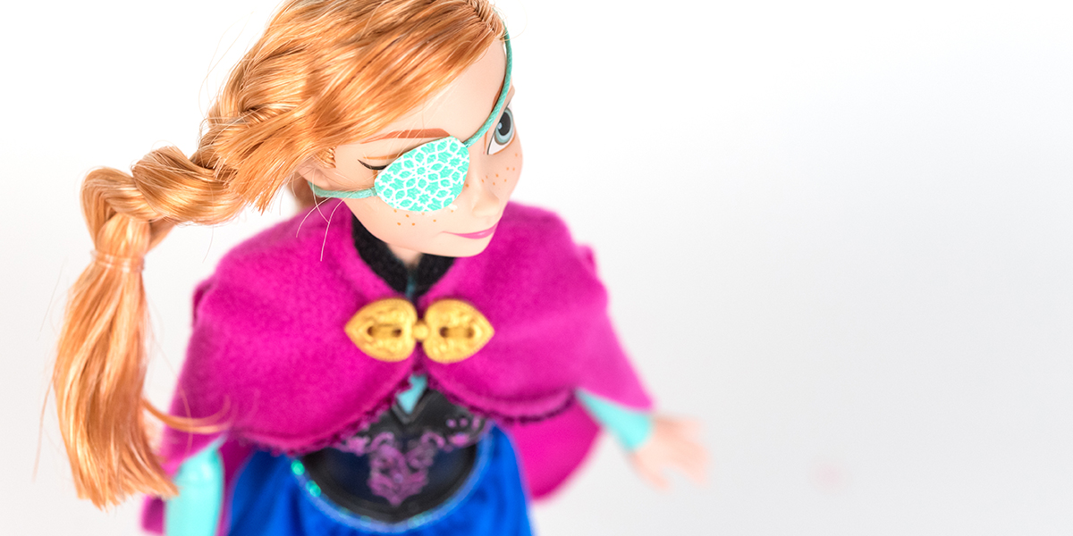 #ToyLikeMe makeover image showing Disney Ana from Frozen doll with a pale aqua eye patch.