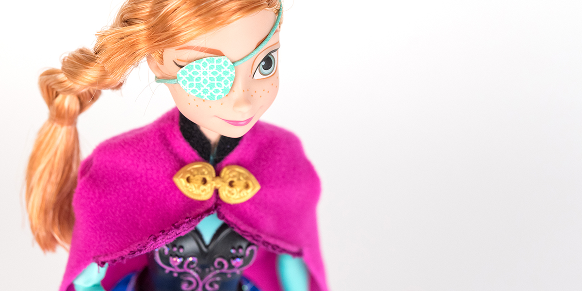#ToyLikeMe makeover image showing Disney Ana from Frozen doll with a pale aqua eye patch.