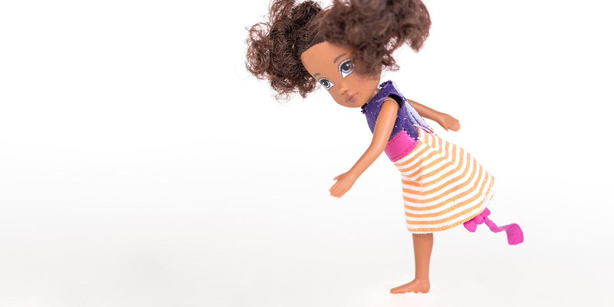 #ToyLikeMe makeover image of Moxie girl doll with pink and purple dress and model prosthetic blade.