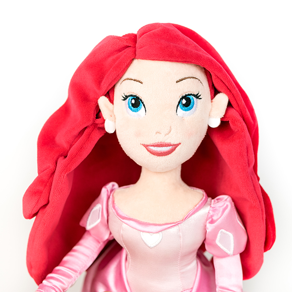 Plush Disney Ariel doll with pink dress and red hair.