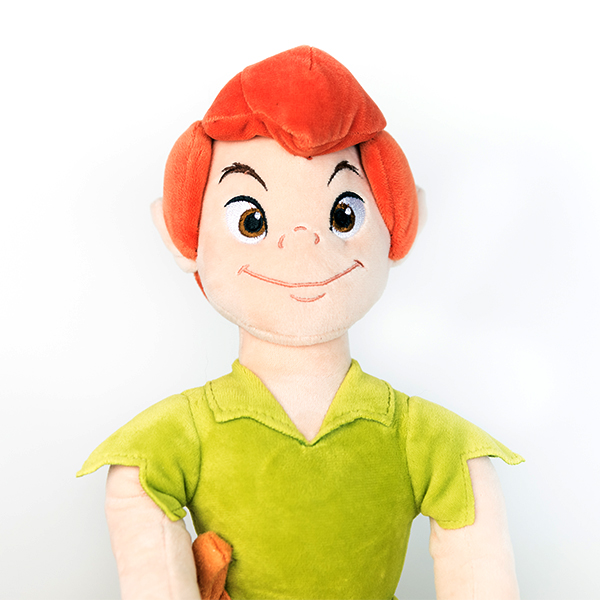 Plush Disney Peter Pan doll with green top and orange hair.