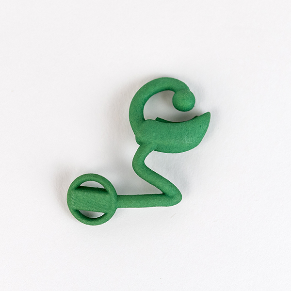 Image show single 3D printed cochlear implant in green.
