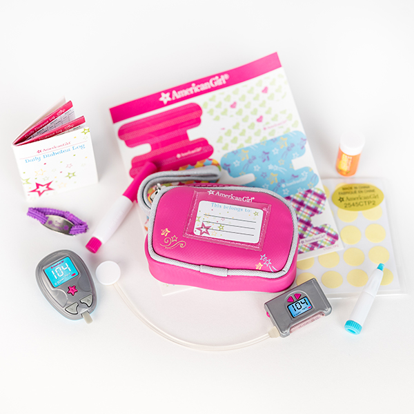 Image shows items from a toy diabetes care kit including pouch, stickers, pen, monitor, log book.