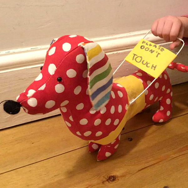Community makeover image showing a plush dog with a home made guide dog harness.