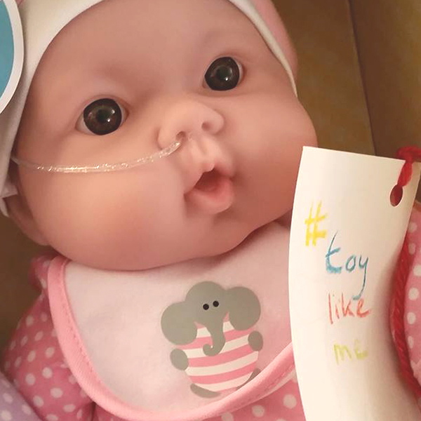 Community makeover image showing baby doll with nasal feeding tube.