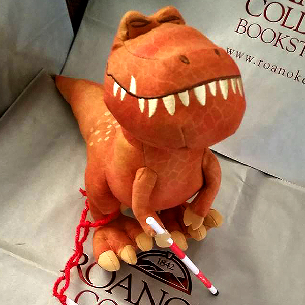 Community makeover image showing plush dinosaur with model red and white cane.