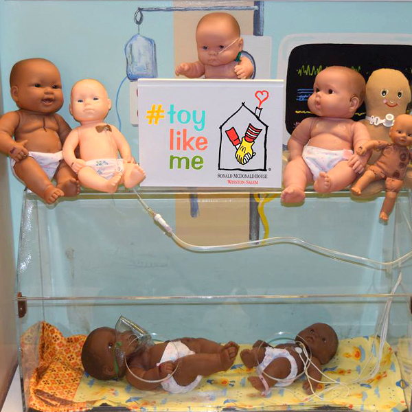 Community makeover image showing a group of baby dolls with different impairments.