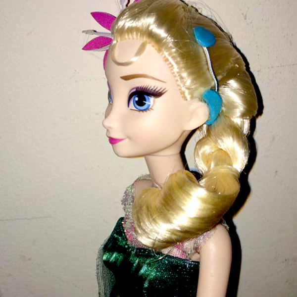 Community makeover image showing Elsa doll with a model cochlear implant.