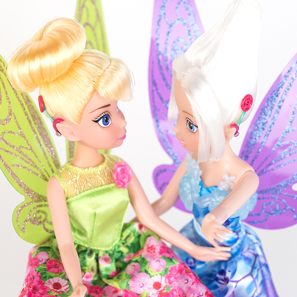 #ToyLikeMe makeover image showing Disney Tinkerbell and Periwinkle dolls with hot pink model cochlear implants.