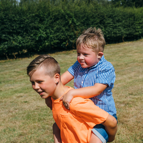 Two boys playing in a field.